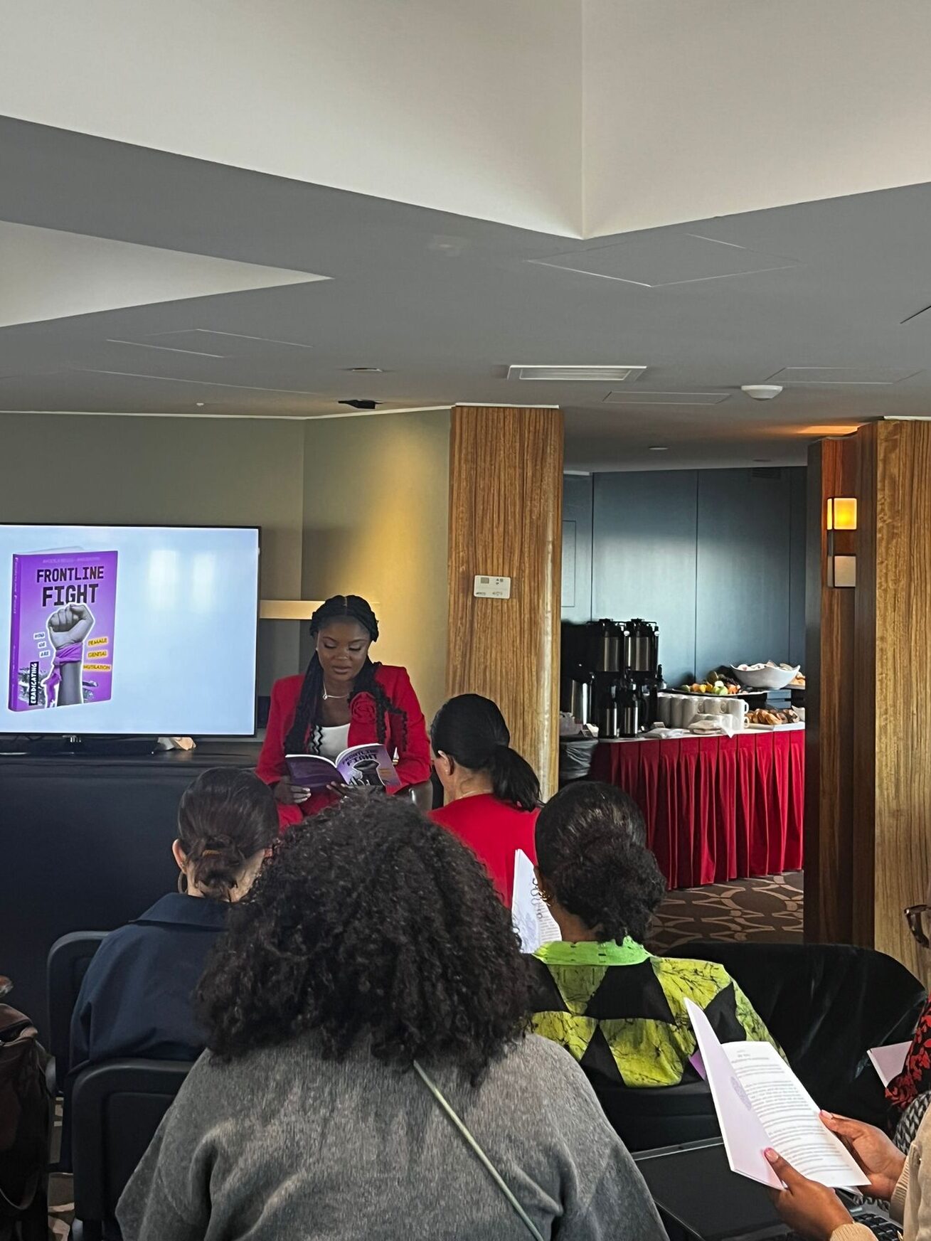 Ayo Bello, author of ‘Frontline Fight’, doing a short reading at the book launch, March 11th 2025